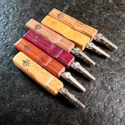 Image of Mystic Timber Pocket Roach dabbers with wooden handles and metal clips, showcasing artisanal craftsmanship.