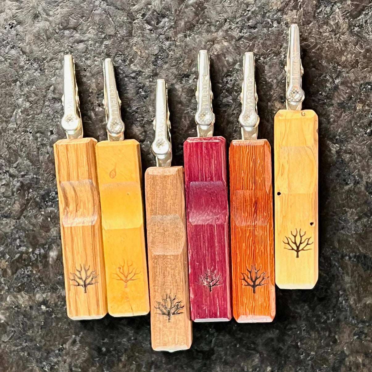 Collection of Mystic Timber Pocket Roach dabbers featuring hardwood handles and unique tree designs.