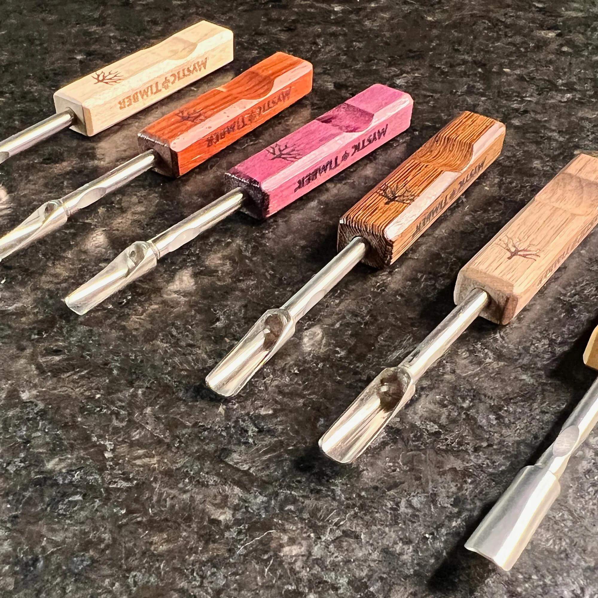 Mystic Timber Dab Tool - Pocket Scoop variety of handcrafted dabbers displayed on a dark surface.