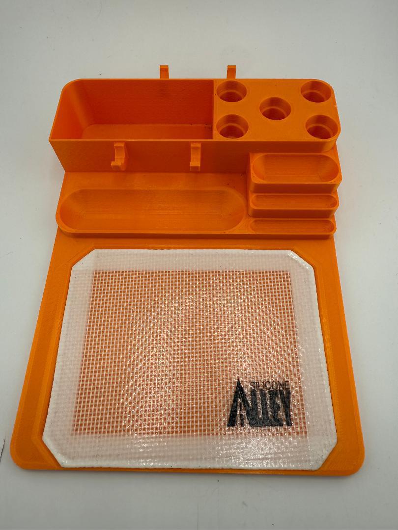 Nikk Drips 3D Printed Dab Station in orange with tool slots and silicone slick work area.