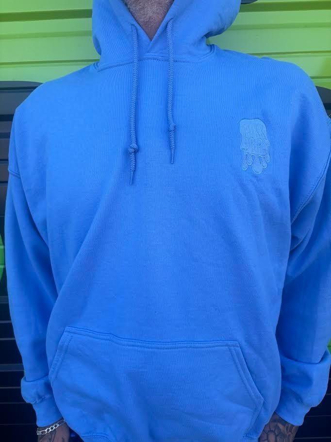 Nikk Drips Hoodie in light blue, showcasing heavy blend fabric and casual style for everyday wear.