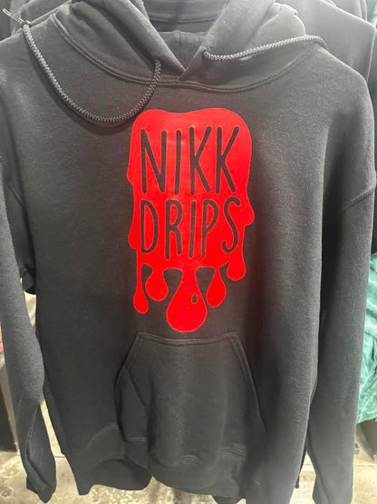 Nikk Drips Hoodie with Vinyl Logo featuring a bold red dripping design on a black cotton hoodie.