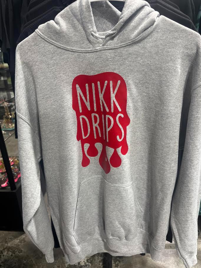 Nikk Drips Hoodie with Vinyl Logo displayed on a gray sweatshirt, featuring a bold red logo design.