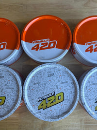 Nikk Drips Mystery Box Tins - Flower Based displayed with Formula 420 collectible tins.