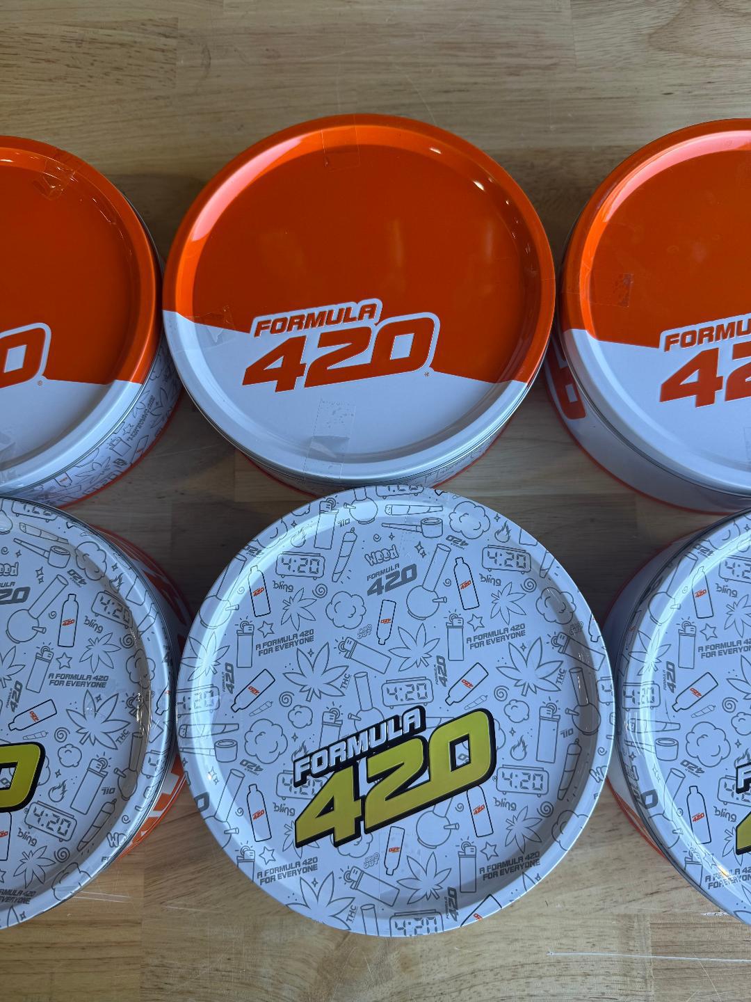 Nikk Drips Mystery Box Tins - Flower Based displayed with Formula 420 collectible tins.