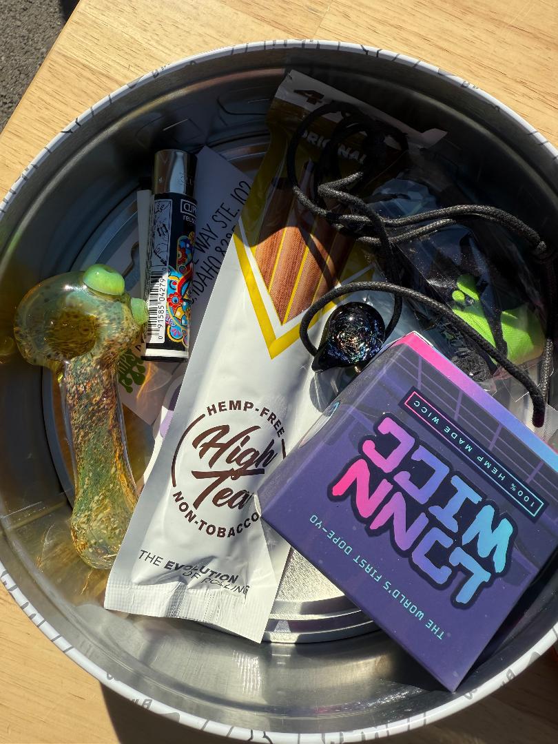Nikk Drips Mystery Box Tins - Flower Based filled with essentials like a chillum and accessories.