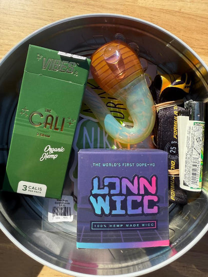 Nikk Drips Mystery Box Tins - Flower Based containing smoke shop essentials and accessories.