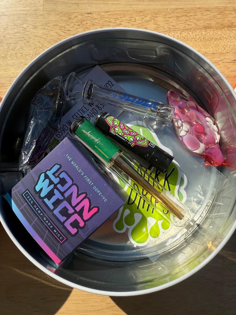 Nikk Drips Mystery Box Tins - Flower Based contents including pipes, accessories, and surprise items in a Formula 420 tin.