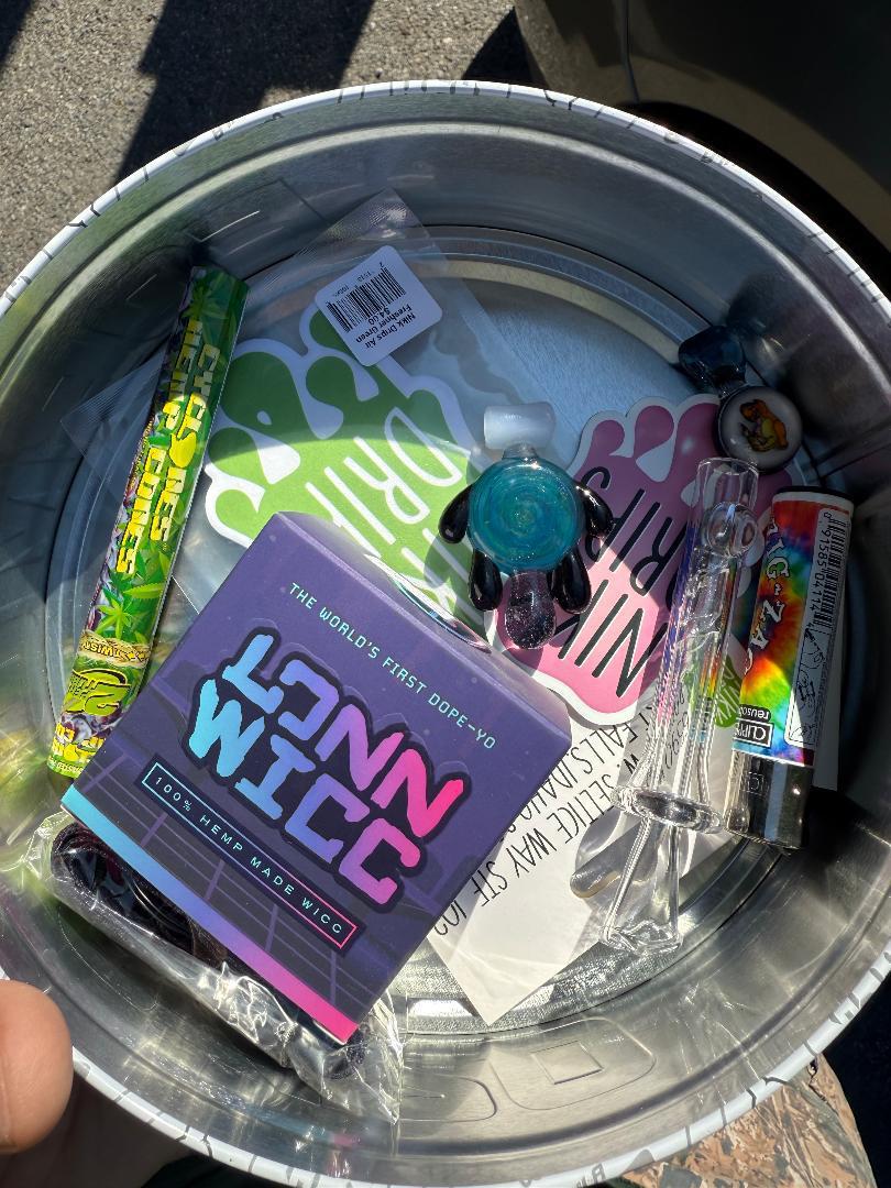 Nikk Drips Mystery Box Tins - Flower Based containing smoke shop essentials and unique accessories in a collectible tin.
