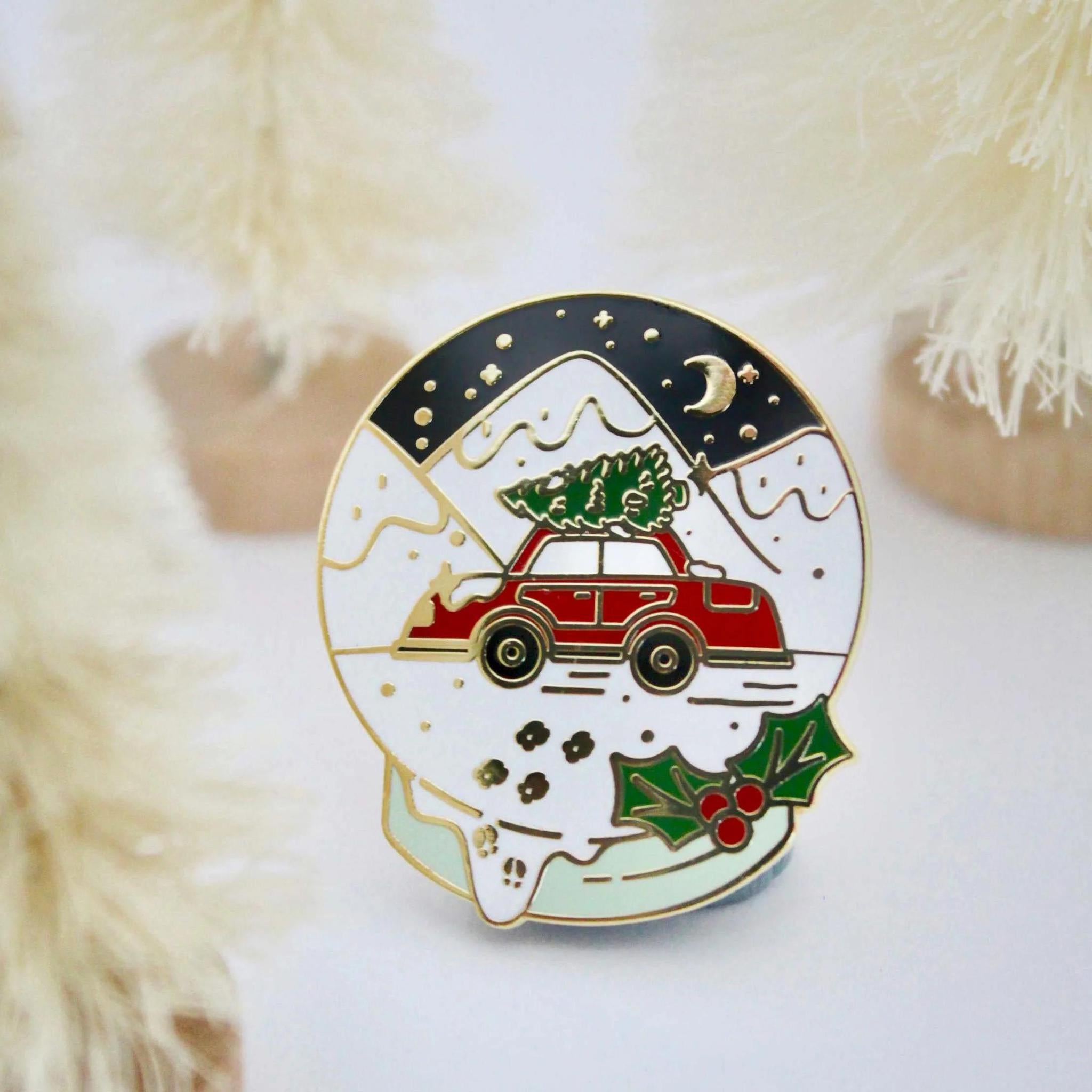 Occasionalish Enamel Pin - Snowglobe featuring a red car with a Christmas tree in a festive snowglobe design.