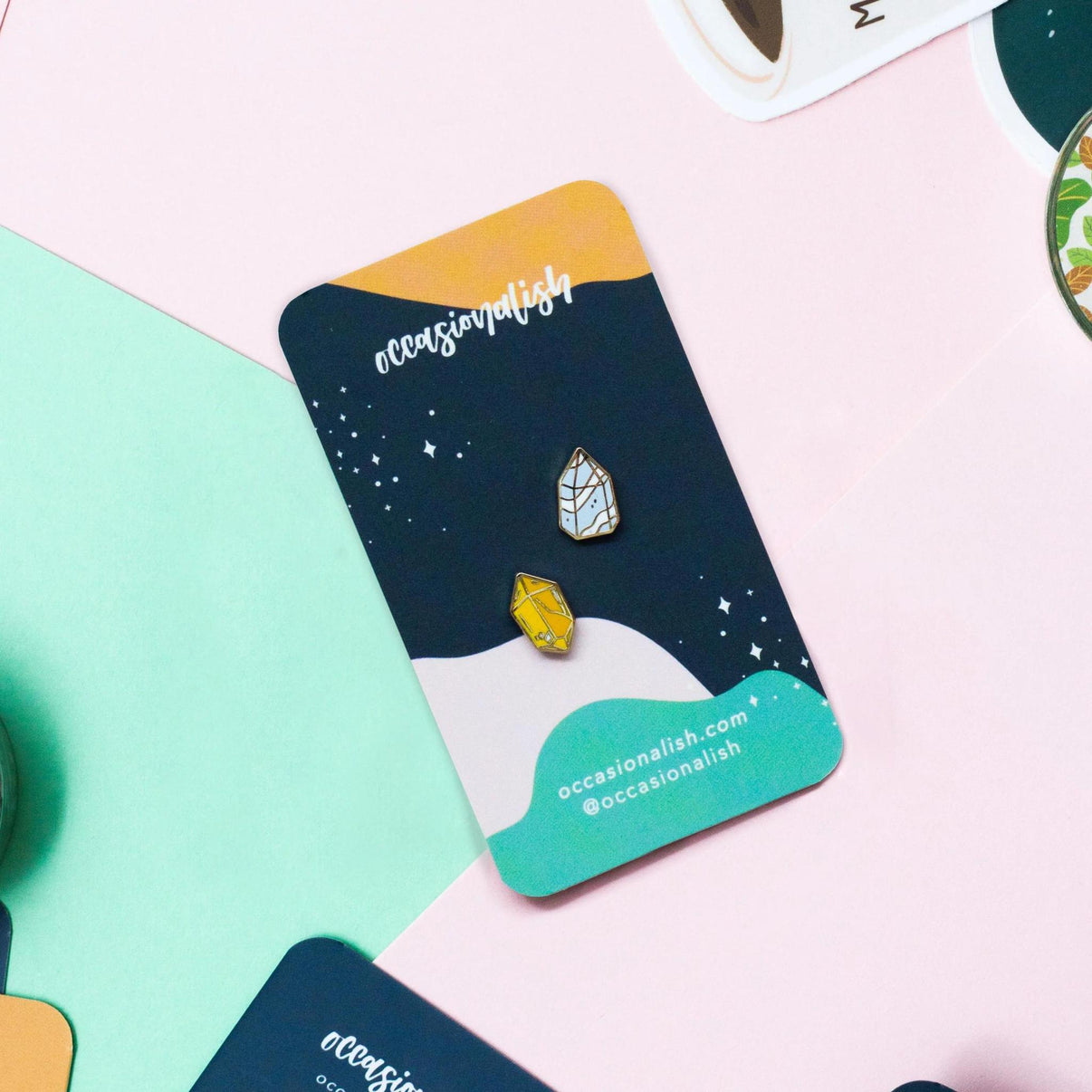 Occasionalish Enamel Pin - Mini Crystal displayed on a colorful card with two tiny crystal-shaped enamel pins.