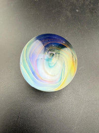 Mop Head Glass Marble - Pastel Vortex 1.2" - 1.5" showcasing a colorful swirl design on a dark surface.