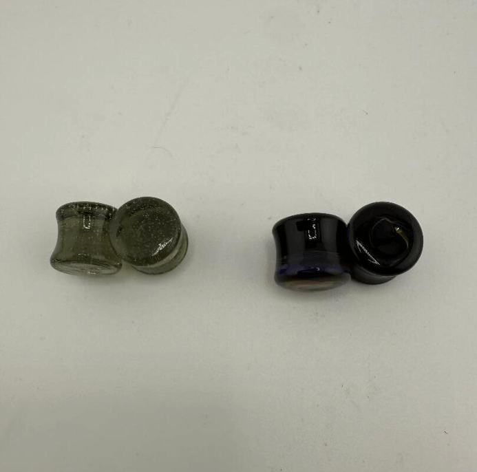 Paulson Pieces 10mm ear plugs in olive green and black borosilicate glass, handcrafted and body-safe.