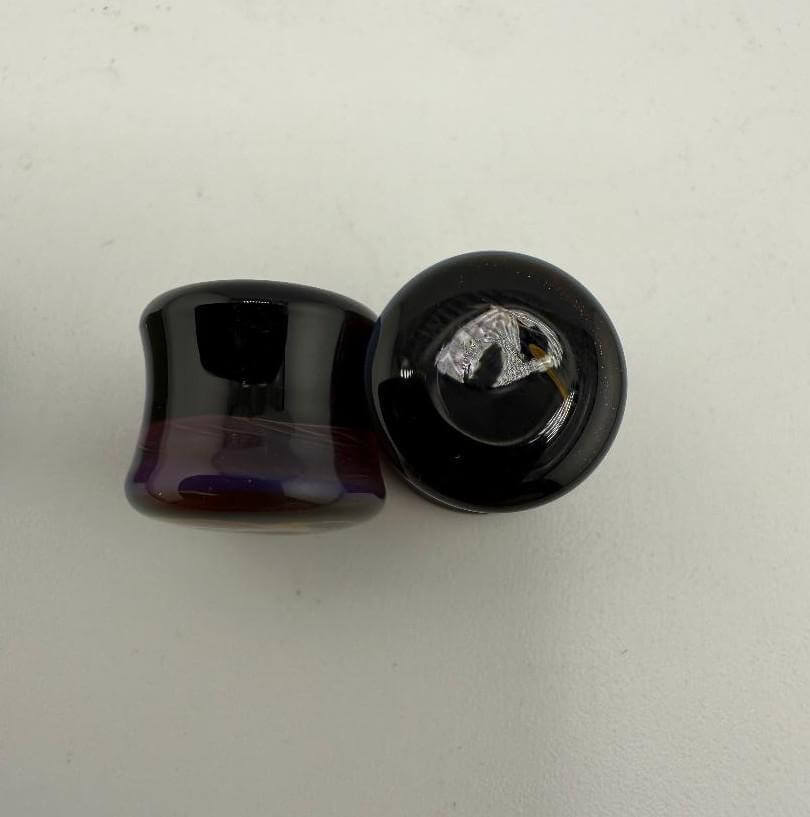 Paulson Pieces 10mm ear plugs made of handcrafted borosilicate glass, showcasing unique colors and artistic design.