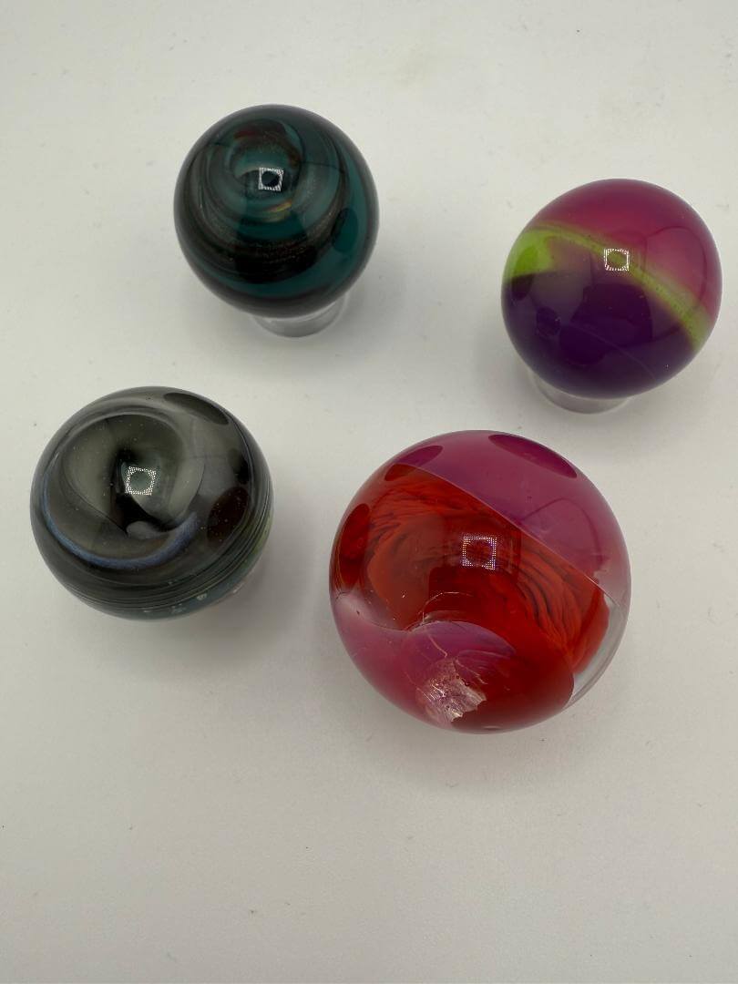 Four handcrafted marbles in various colors, ideal for enhancing slurper banger performance and visual appeal.