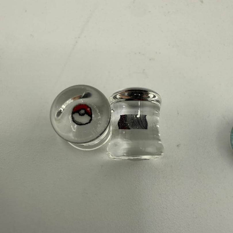 Paulson Pieces 8mm ear plugs featuring Pokeball design, handcrafted borosilicate glass, unique style for stretched ears.