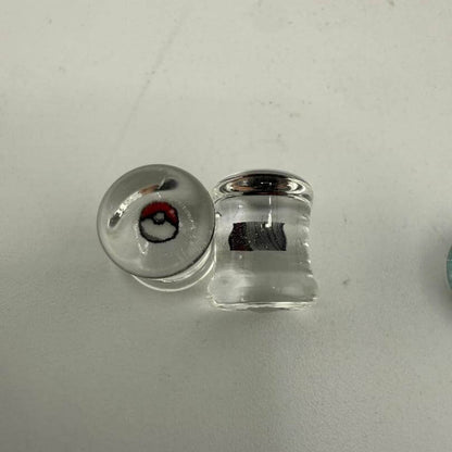 Paulson Pieces 8mm ear plugs featuring Pokeball design, handcrafted borosilicate glass, unique style for stretched ears.