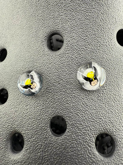Close-up of Paulson Pieces Glass Kroc Giblets featuring pop culture designs on a textured surface.