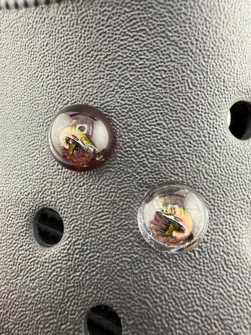 Close-up of Paulson Pieces glass Kroc giblets with pop culture designs, showcasing intricate details and colors.