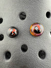 Close-up of Paulson Pieces Glass Kroc Giblets showcasing two handcrafted glass accessories with pop culture designs.