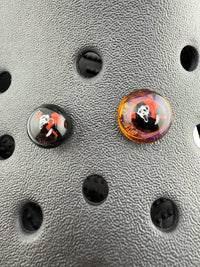 Close-up of Paulson Pieces Glass Kroc Giblets showcasing two handcrafted glass accessories with pop culture designs.