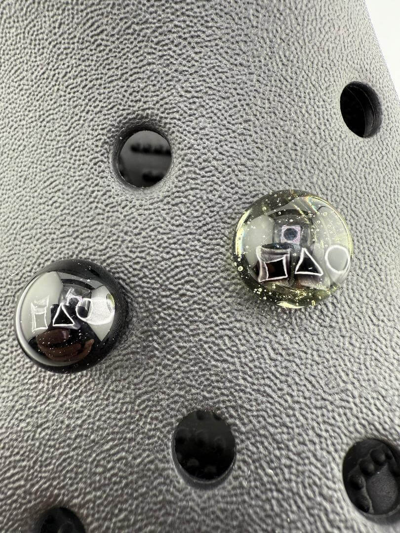 Close-up of Paulson Pieces glass Kroc giblets featuring iconic pop culture designs on detailed surface.
