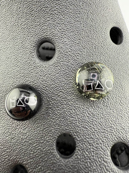 Close-up of Paulson Pieces glass Kroc giblets featuring iconic pop culture designs on detailed surface.
