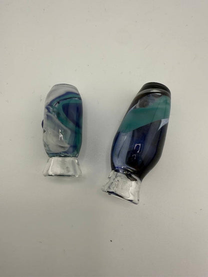 Two handcrafted glass pivot tops in blue and green swirls for Puffco Peak Pro, showcasing unique aesthetics.