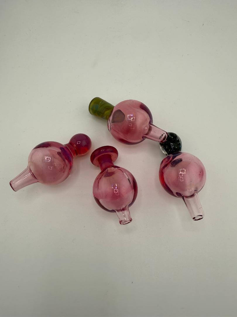 Four Paulson Pieces Telemagenta 24mm bubble caps in varying pink shades, perfect for enhancing smoking experience.