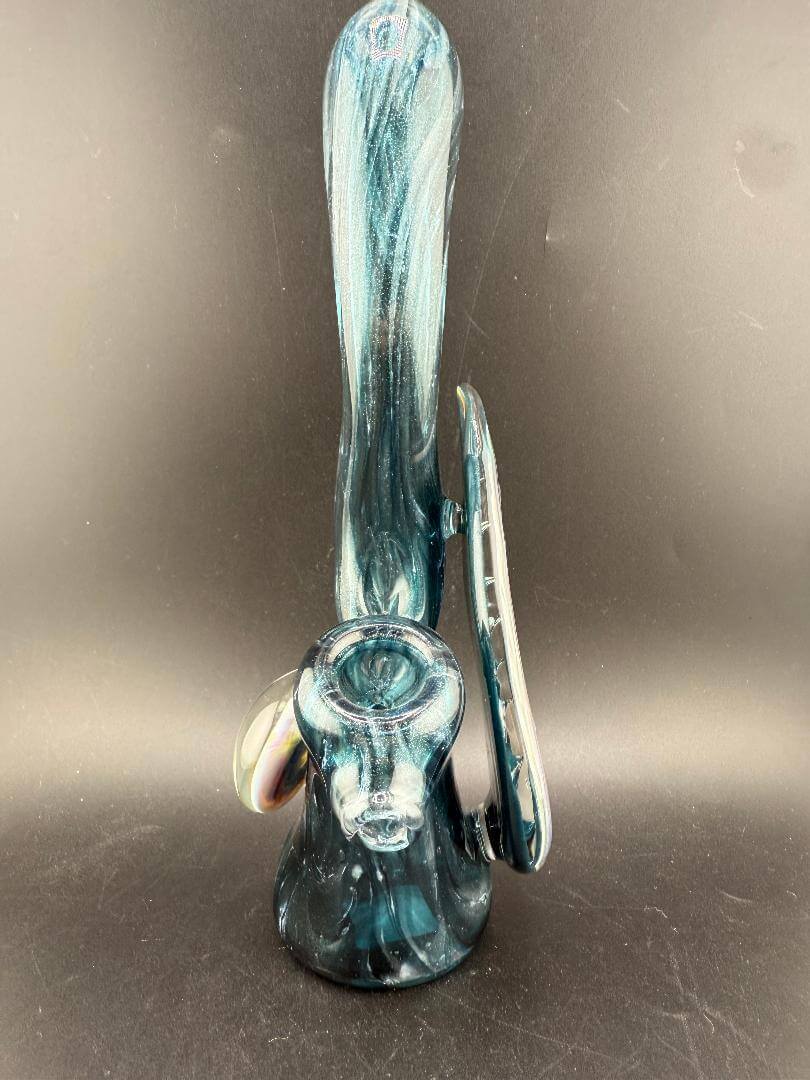Phranq Glass Bubbler - Blue Stardust w/ Fumed Chaos Pendant & Large Leaf on a dark background, showcasing its elegant design.