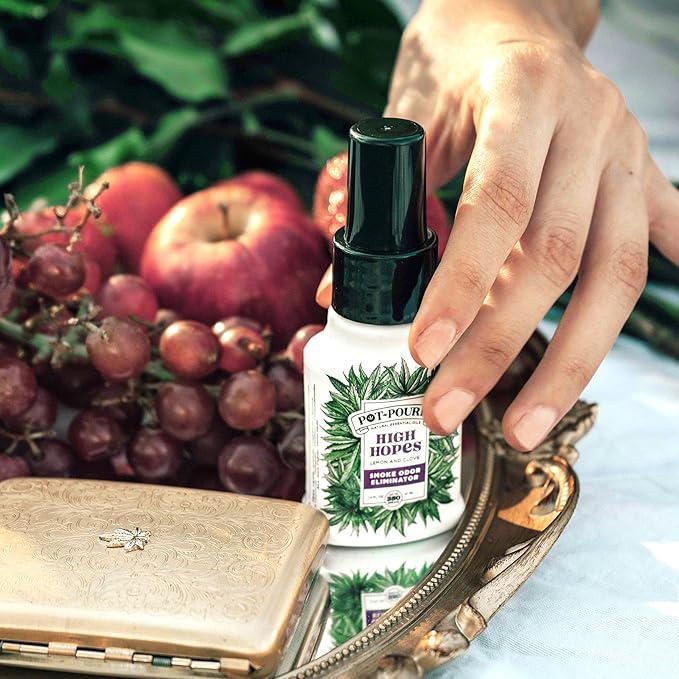 Pot-Pourri Smoke Odor Freshener Spray High Hopes 1.4 Fl Oz - Lemon and Clove next to fruit on an elegant tray.