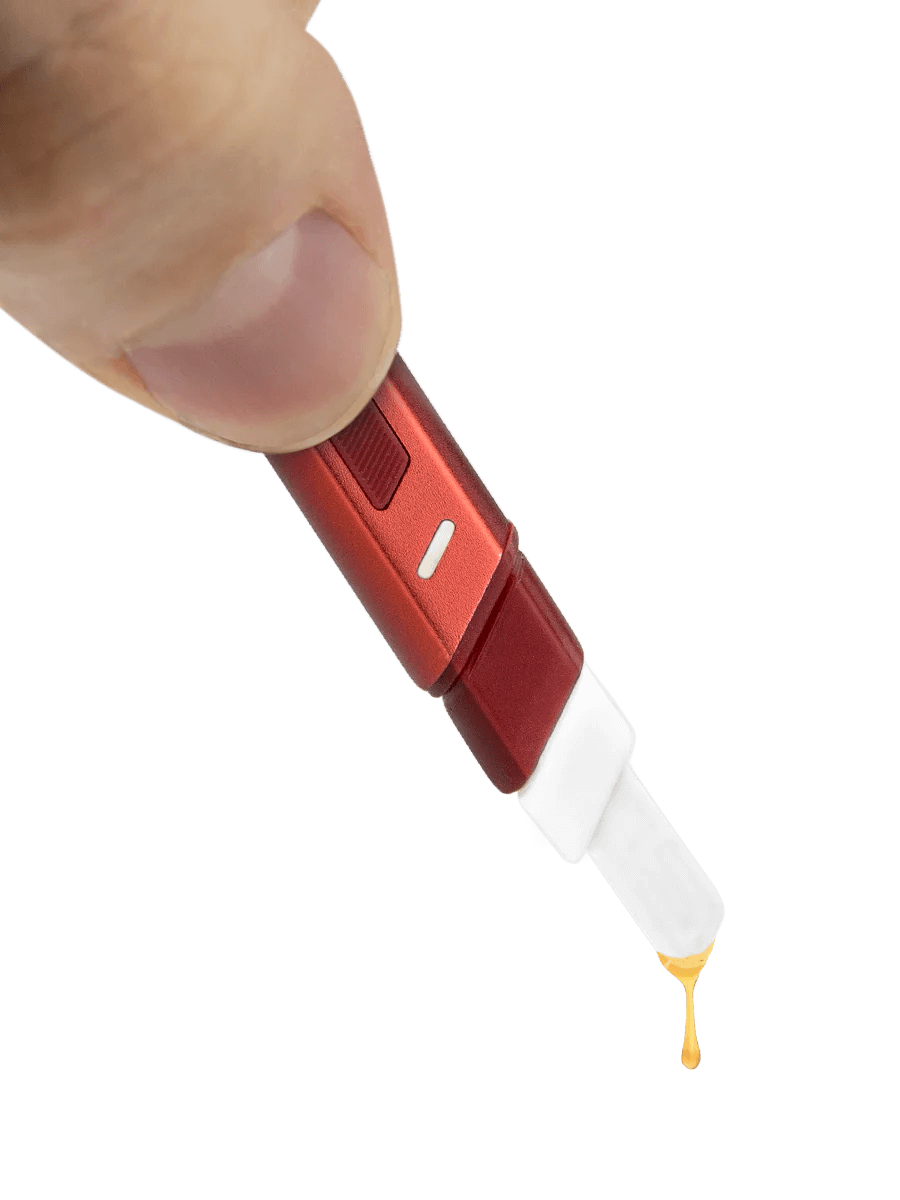 Puffco Hot Knife heating tool in hand, with extract dropping from the ceramic tip.