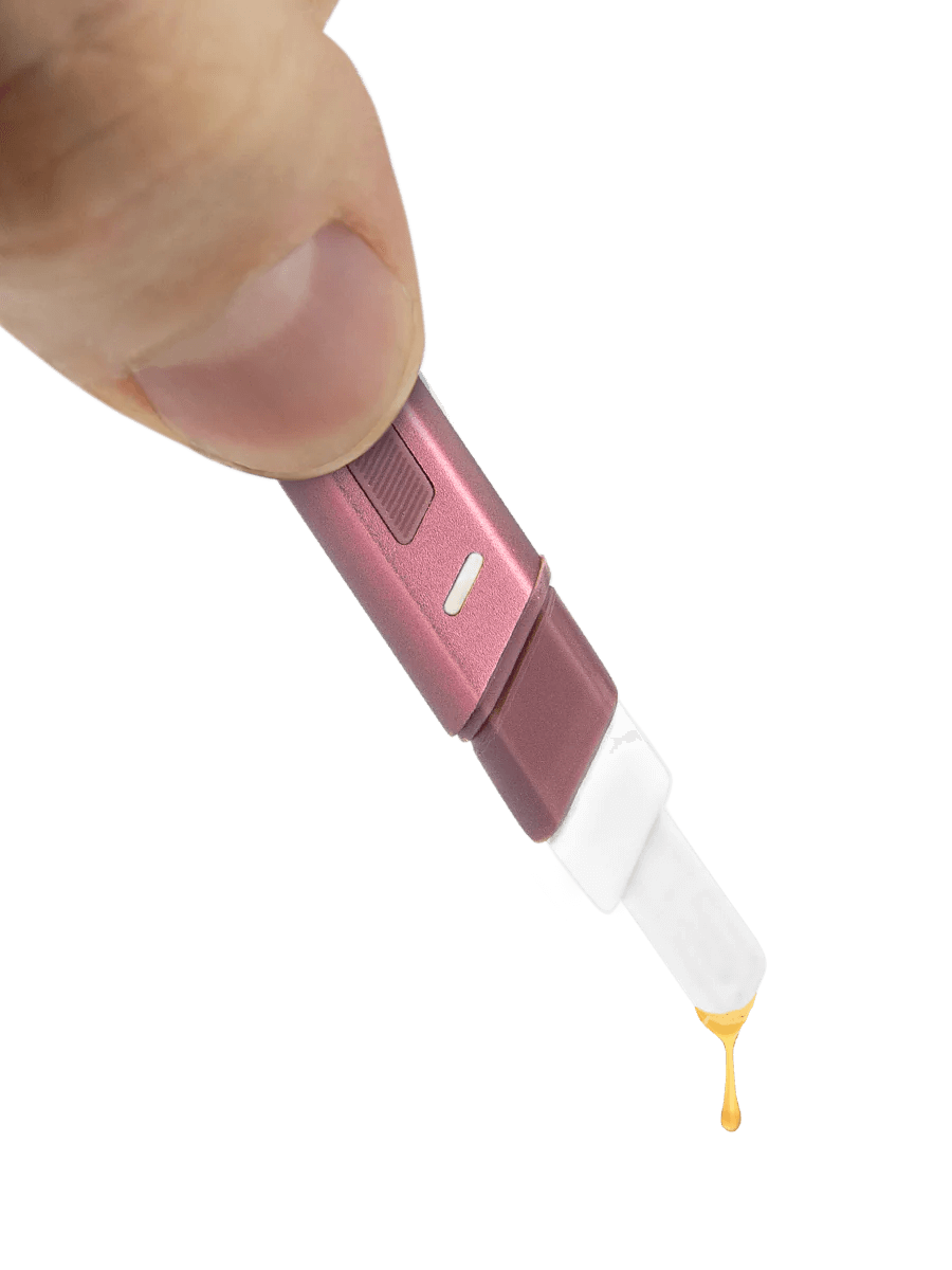 Puffco Hot Knife heated loading tool in hand, dispensing extract, showcasing its USB-C charging and ceramic tip features.
