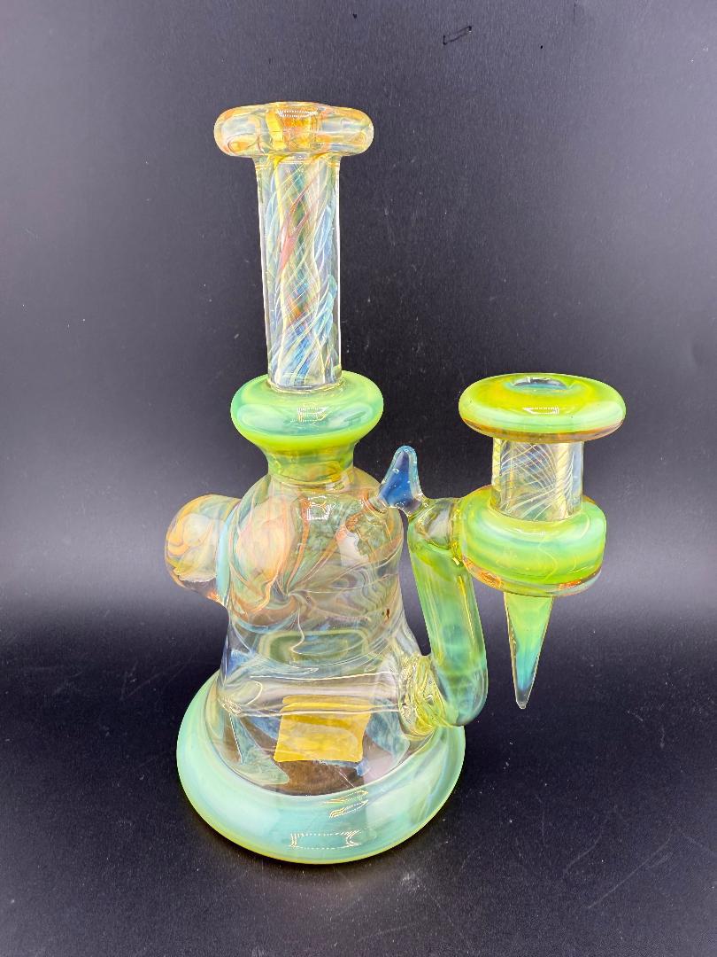 Pugsley Glass Green Worked Rig 10mm 90° with vibrant green accents, handcrafted artistic design, showcasing heady glass craftsmanship.