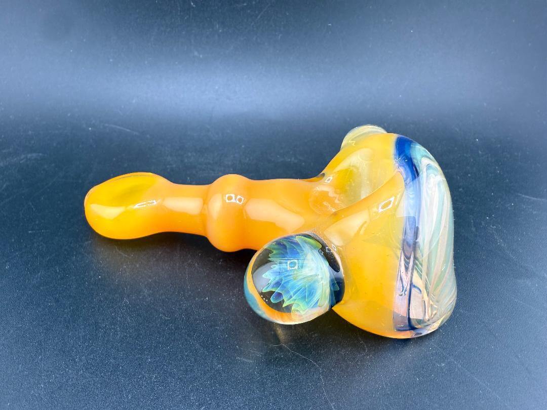 Pugsley Glass Hand Pipe - Orange w/ Fumed Cap & Marble Attachment on a black background.