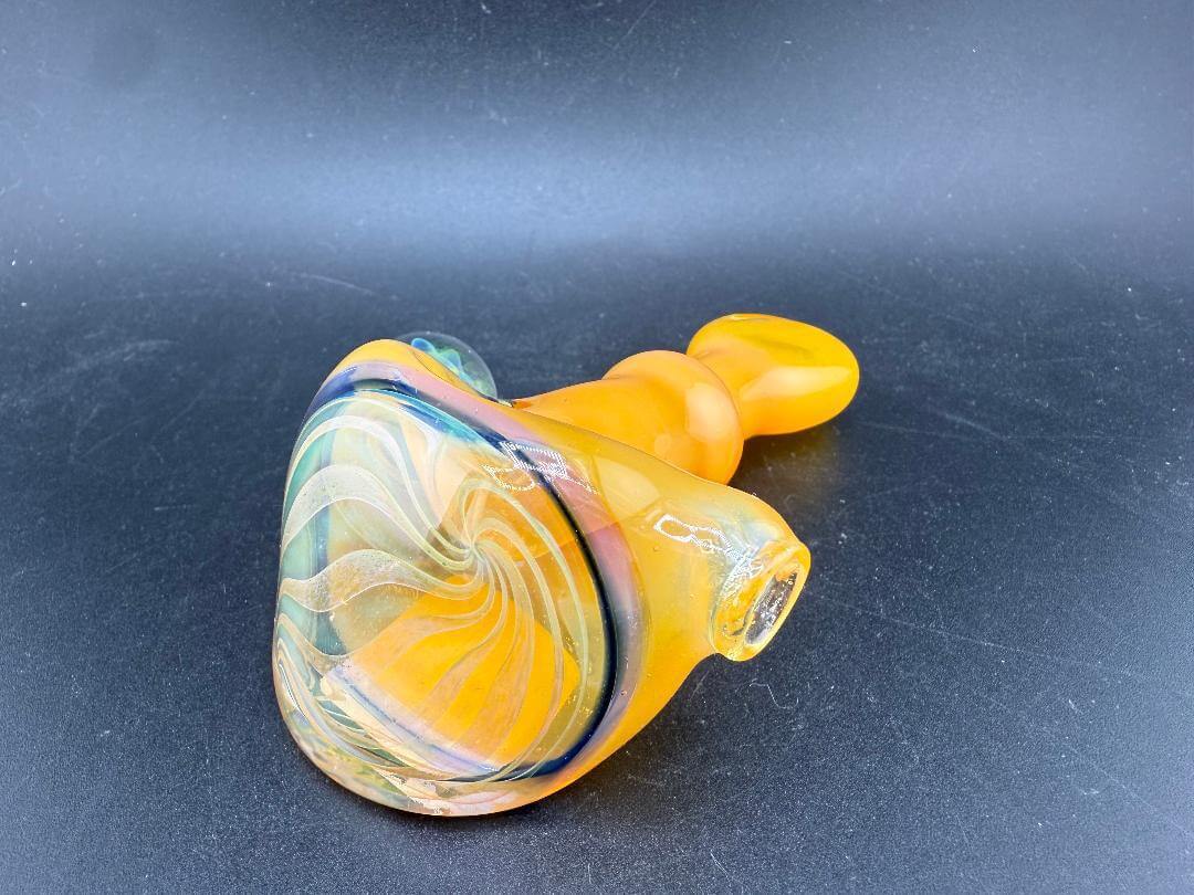 Pugsley Glass Hand Pipe - Orange w/ Fumed Cap & Marble Attachment on a black background, highlighting its vibrant design.