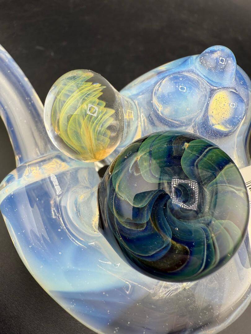Pugsley Glass Sherlock Pipe - Ghost White w/ Leaf Attachment & Encased Opal showcasing vibrant glass colors and intricate designs.