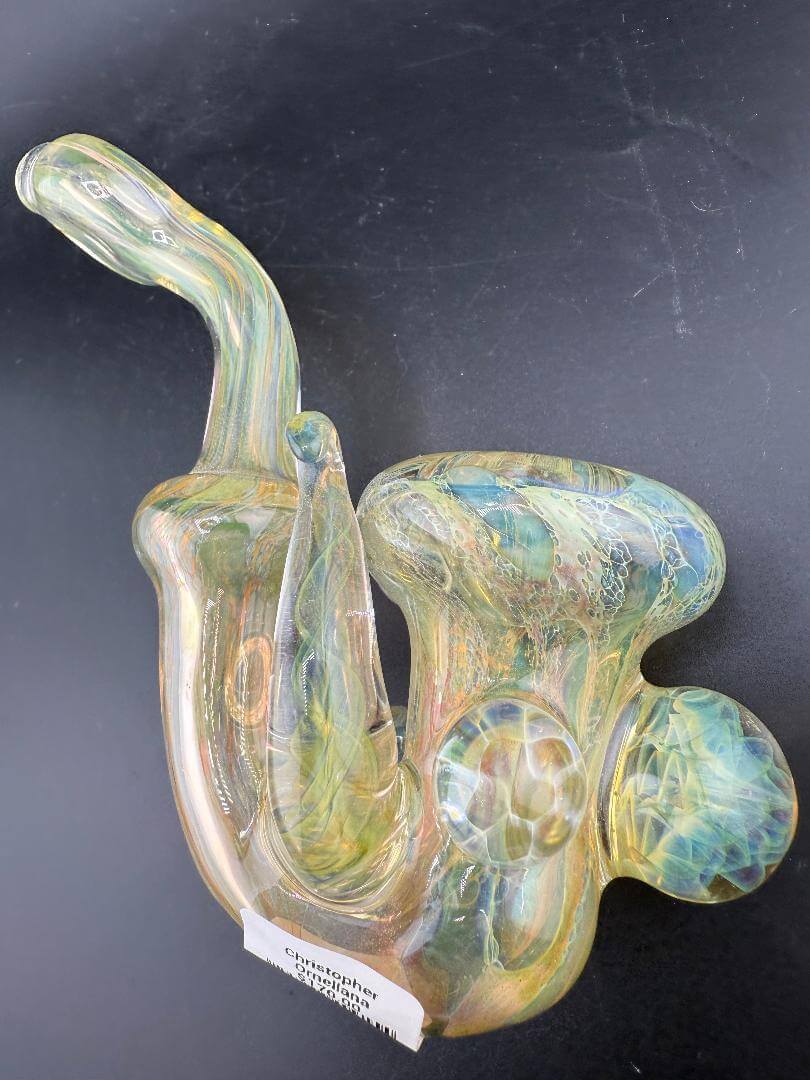 Pugsley Glass Sherlock Pipe - Gold Fumed w/ Fumed Implosion Marbles & Encased Opals elegantly displayed on a black backdrop.