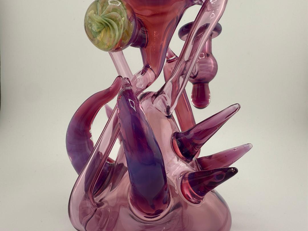 Handmade Pugsley Glass Stargazer Spike Recycler in purple and pink, showcasing unique heady glass design and smooth functionality.
