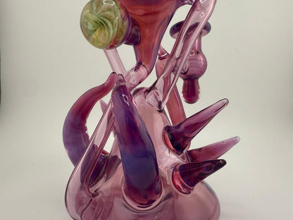 Handmade Pugsley Glass Stargazer Spike Recycler in purple and pink, showcasing unique heady glass design and smooth functionality.