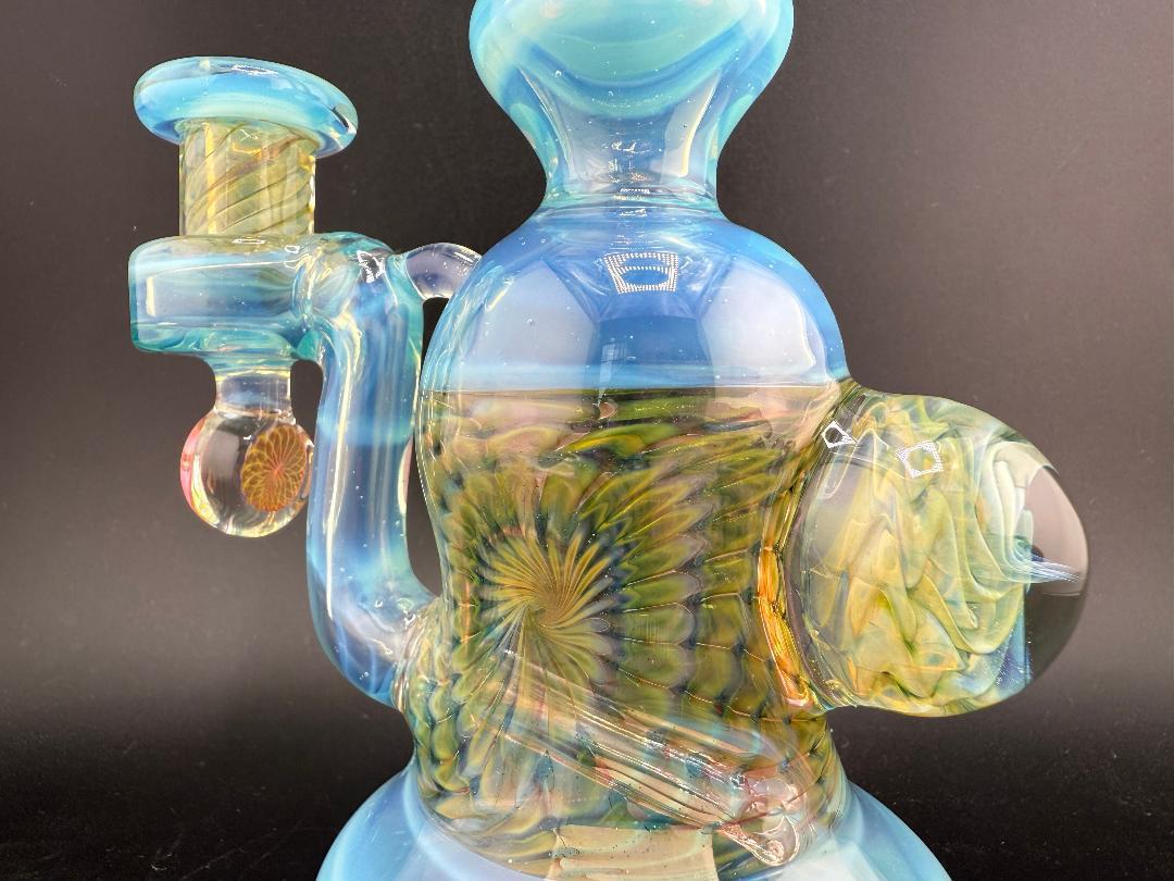 Pugsley Glass Worked Banger Hanger with blue accents and intricate designs, handcrafted for superior concentrate performance.