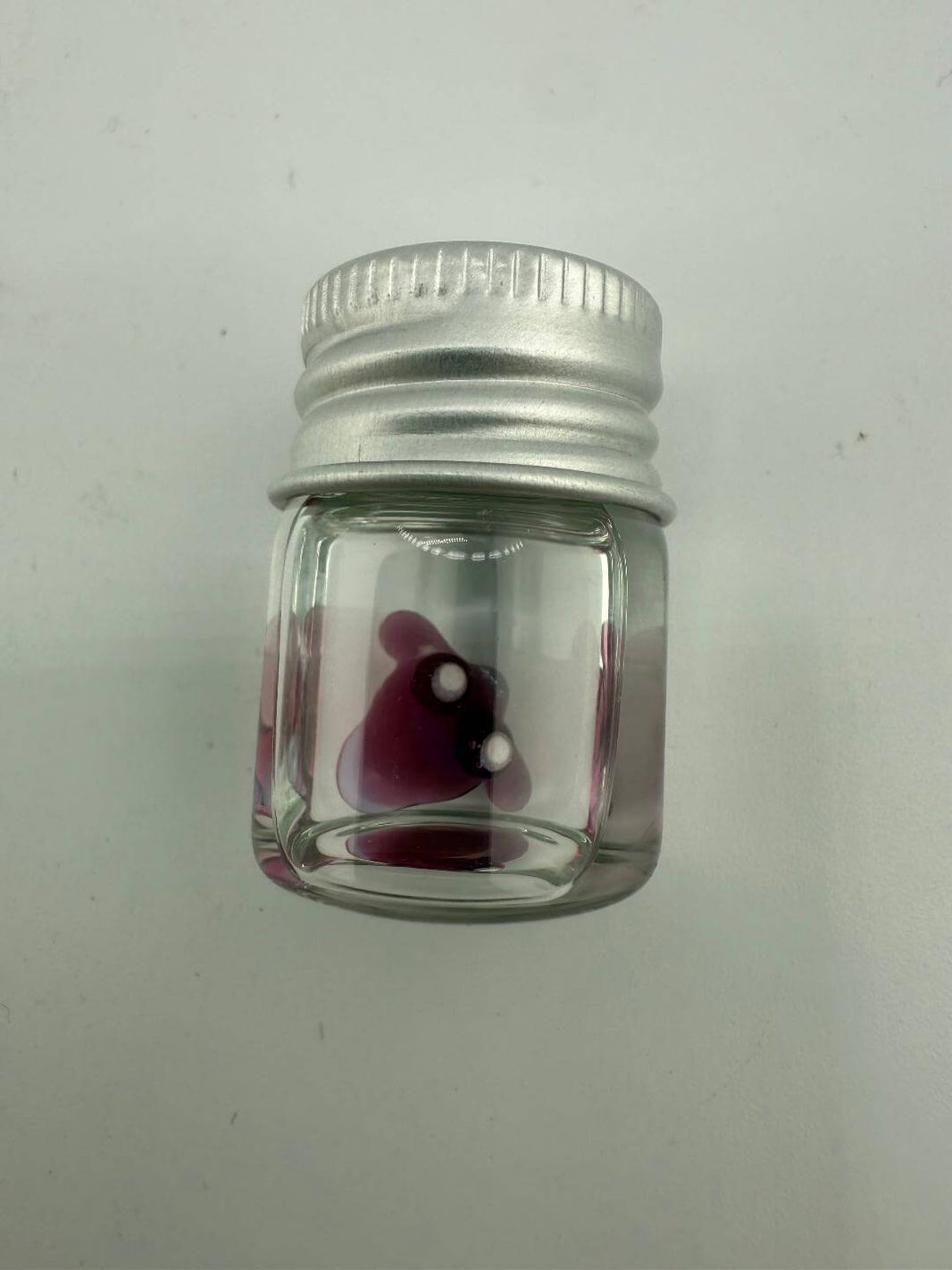 Lucky Gnome Glass Terp Pearl in a clear jar with a silver cap, featuring a playful purple design.