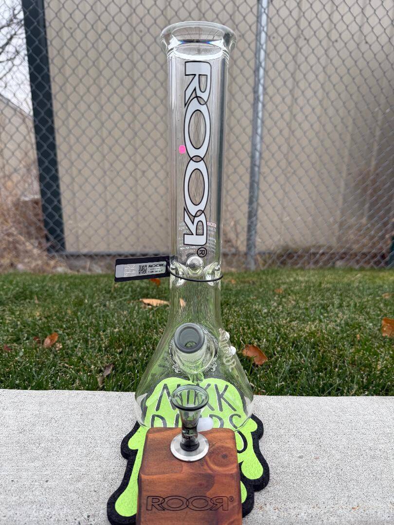 ROOR Glass 14" Beaker 50x5mm Collector Series Beaker - Smoke displayed on a wooden stand with green accents.