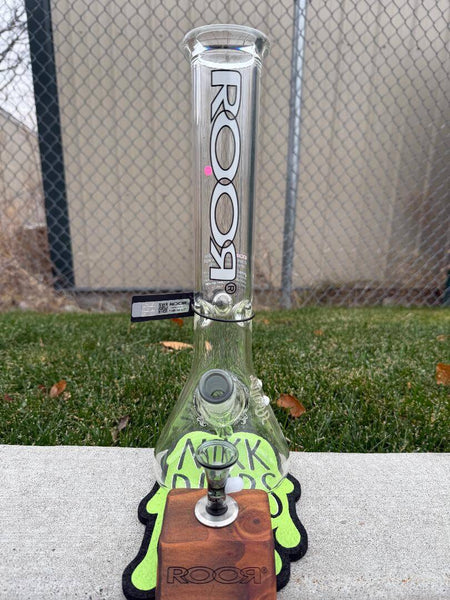 ROOR Glass 14" Beaker 50x5mm Collector Series Beaker - Smoke displayed on a wooden stand with green accents.