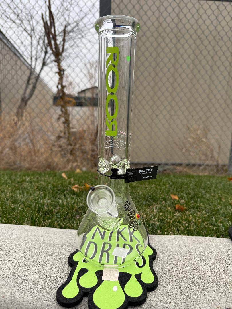 ROOR Glass 14" Beaker 50 x 7mm Thick 14mm 45° - Green on a NIKI DRIPS mat outdoors.