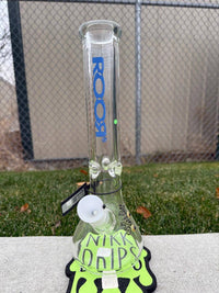 ROOR Glass14" Beaker 50 x 9mm Thick - Blue displayed on grass with a vibrant design and branding.