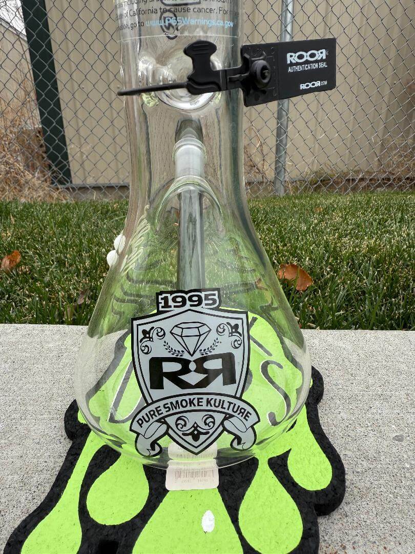 ROOR Glass 14" Beaker 50x5mm Collector Series Beaker - Smoke displayed on a colorful mat with logo and tag.