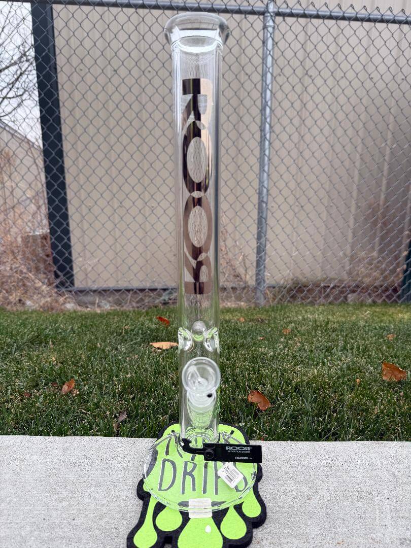 ROOR Glass 18" Straight Tube 45x5mm Thick - Gold Logo displayed on a grassy surface with a drip mat.