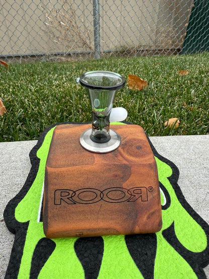 ROOR Glass 14" Beaker 50x5mm Collector Series Beaker - Smoke displayed on a wooden stand with a glass bowl.