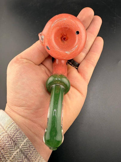 Rosie Works Glass Sherlock Pipe - Watermelon Seeds Included held in a hand with a playful watermelon-inspired design.
